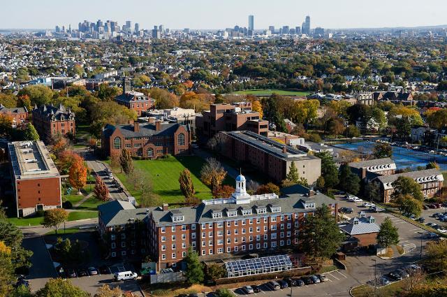 Aerial view of Tufts campus, with Boston skyline in background.