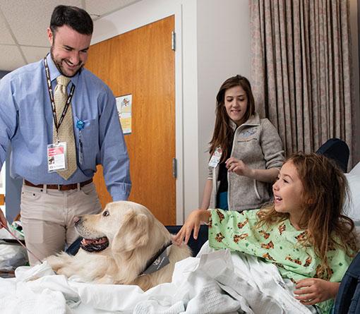 Connor O’Boyle, MG17 (MBS), M21, and Dublin, his golden retriever at the Floating Hospital for Children