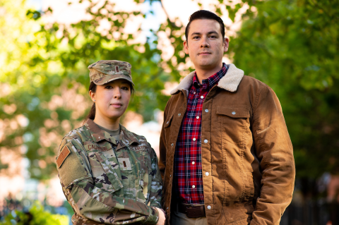 Air Force Lieutenant Miki Calderon, M24, and her husband Randy pose for a portrait at the Tufts University School of Medicine